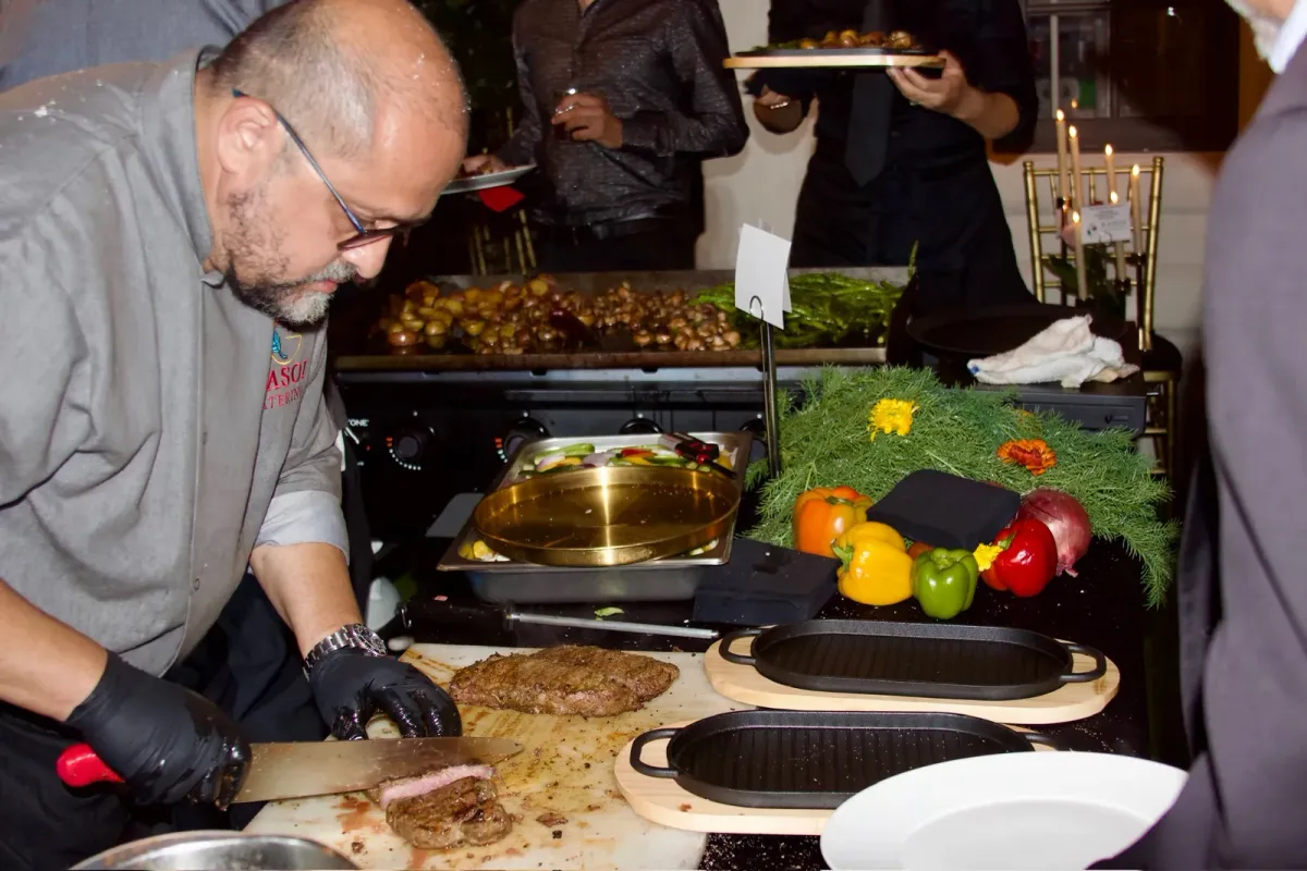 Rasoi Catering chef carving at a live station with fresh vegetables