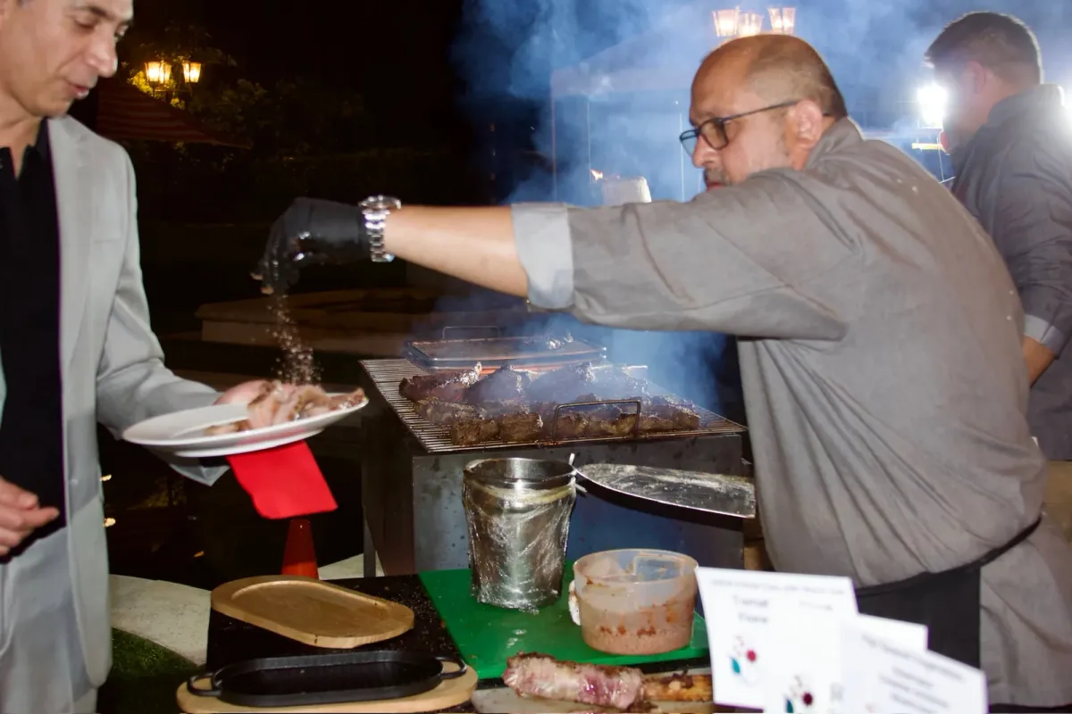 Rasoi Catering chef working a live grill station at an evening event