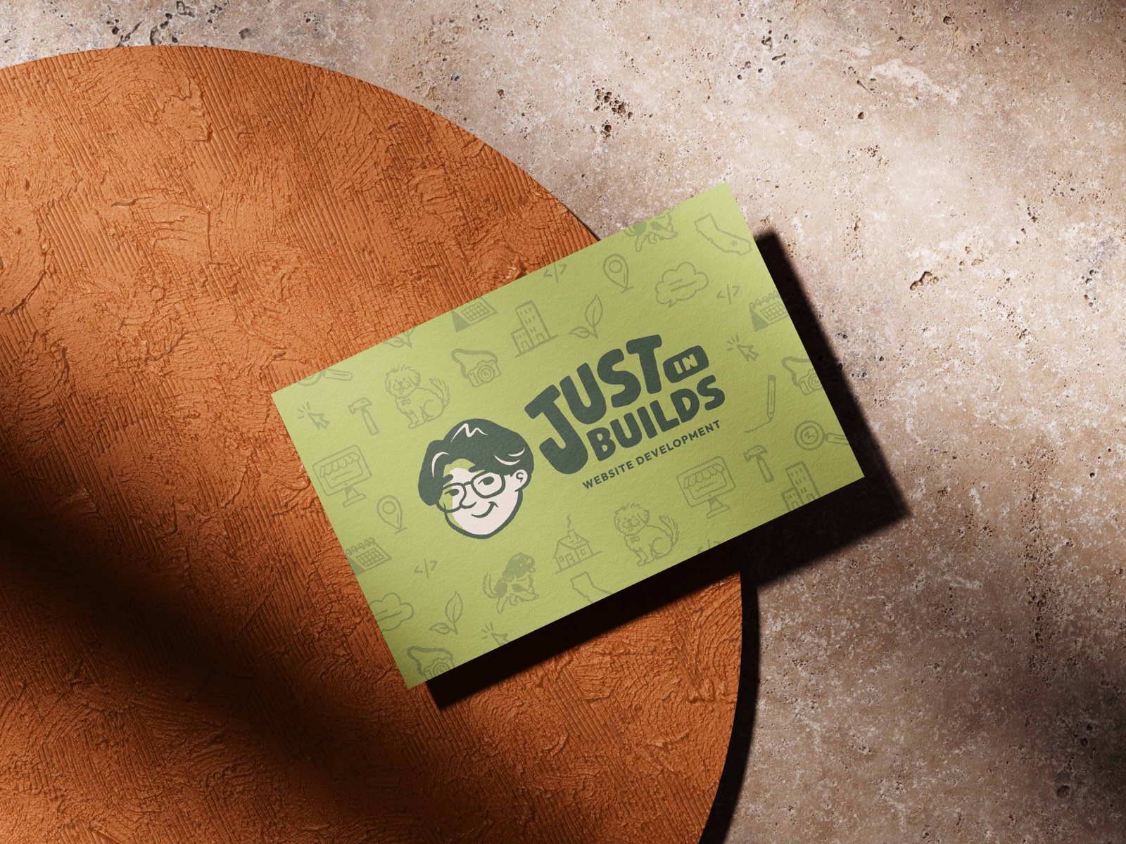 The front of Justin's Just In-Builds business card: the lime card with his face, the wordmark and the icon pattern